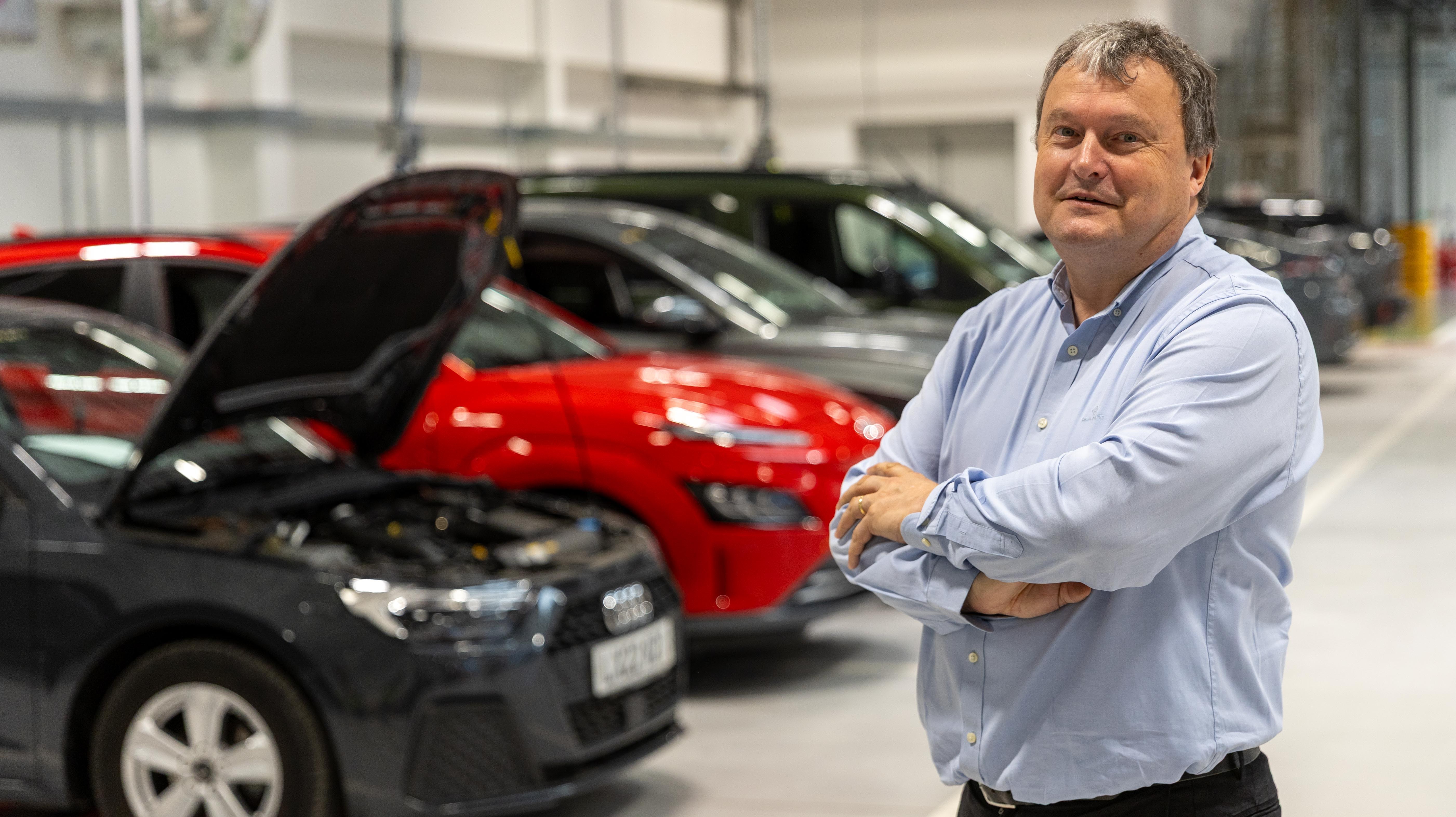 Andrew Miller, Motability CEO, in a vehicle showroom.