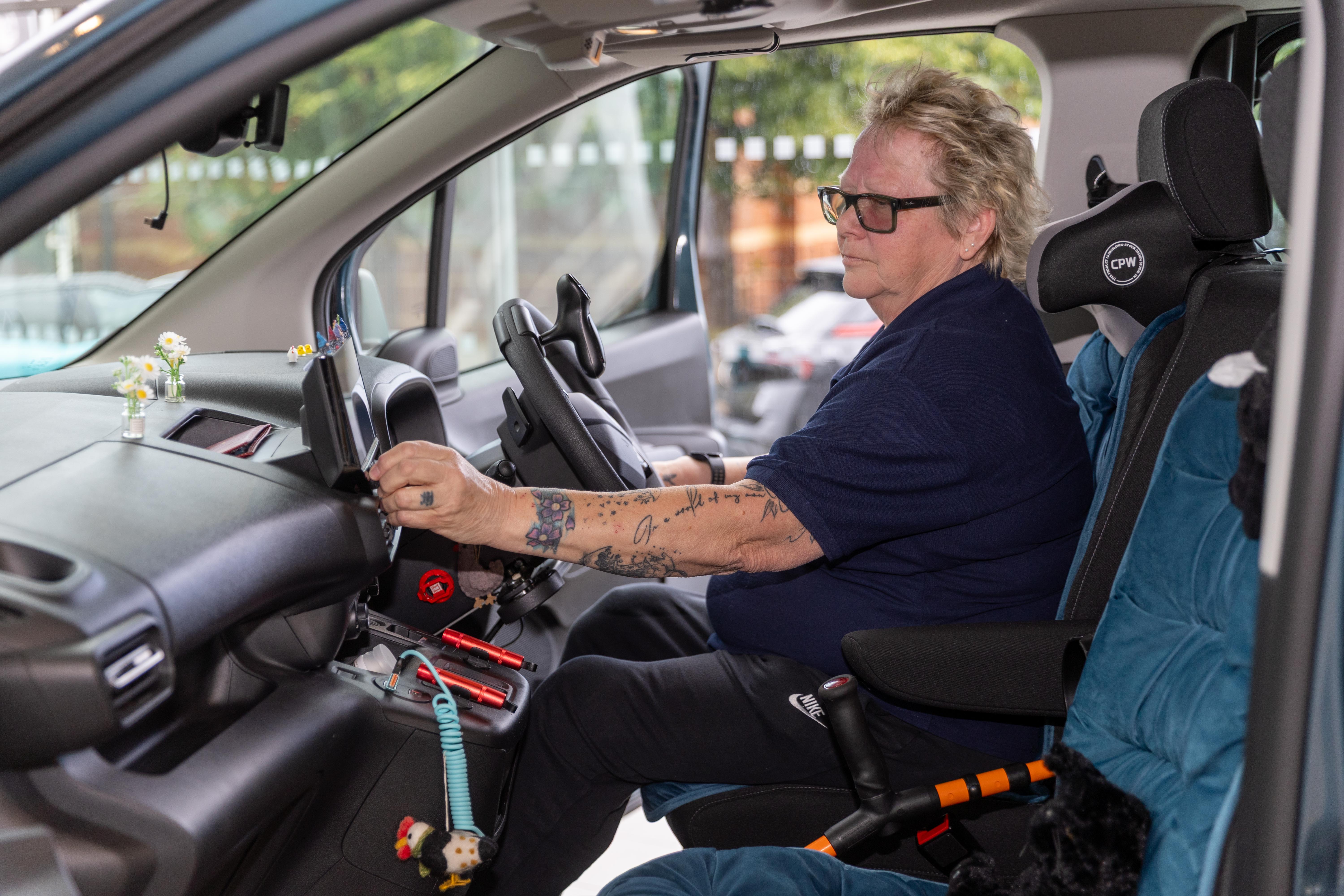 Woman in an adapted Vauxhall vehicle.